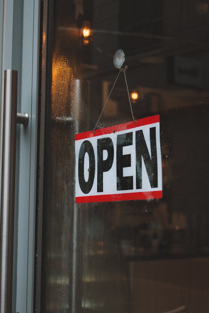 Inviting café entrance featuring an open sign on a glass door.